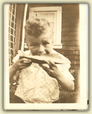 Warren as a boy, eating watermellon